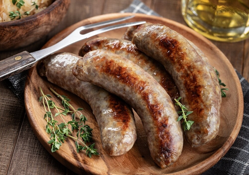 Cooked pineapple teriyaki bratwurst on serving plate, golden brown and ready to eat