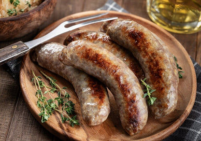 Cooked pineapple teriyaki bratwurst on serving plate, golden brown and ready to eat
