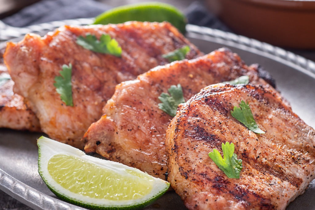 Plated boneless pork chops with simple sides, cooked from local Indiana pork