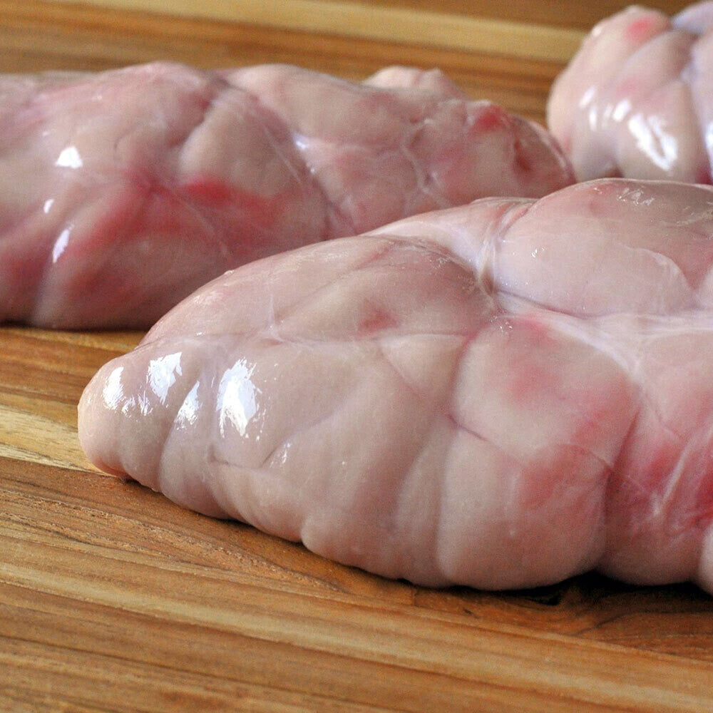 Raw beef sweetbreads on cutting board, sourced from pasture-raised cattle at Tyner Pond Farm