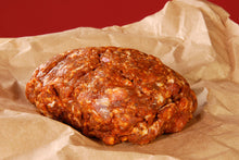 Raw Cajun-style pork sausage on butcher paper, ground and ready to cook