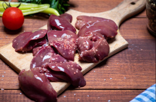 Raw pasture-raised chicken livers on cutting board, ready for cooking, from Tyner Pond Farm