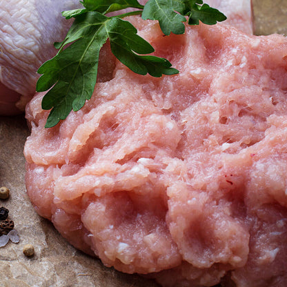 Raw pasture-raised ground chicken in bowl, 1 lb portion from Tyner Pond Farm