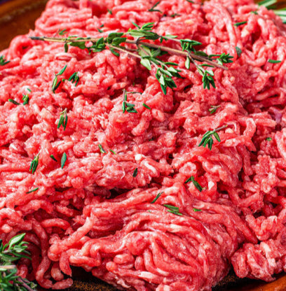 Side view of raw ground round with visible lean texture, made from grassfed beef