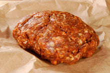 Raw ground hot Italian sausage on butcher paper, ready to cook