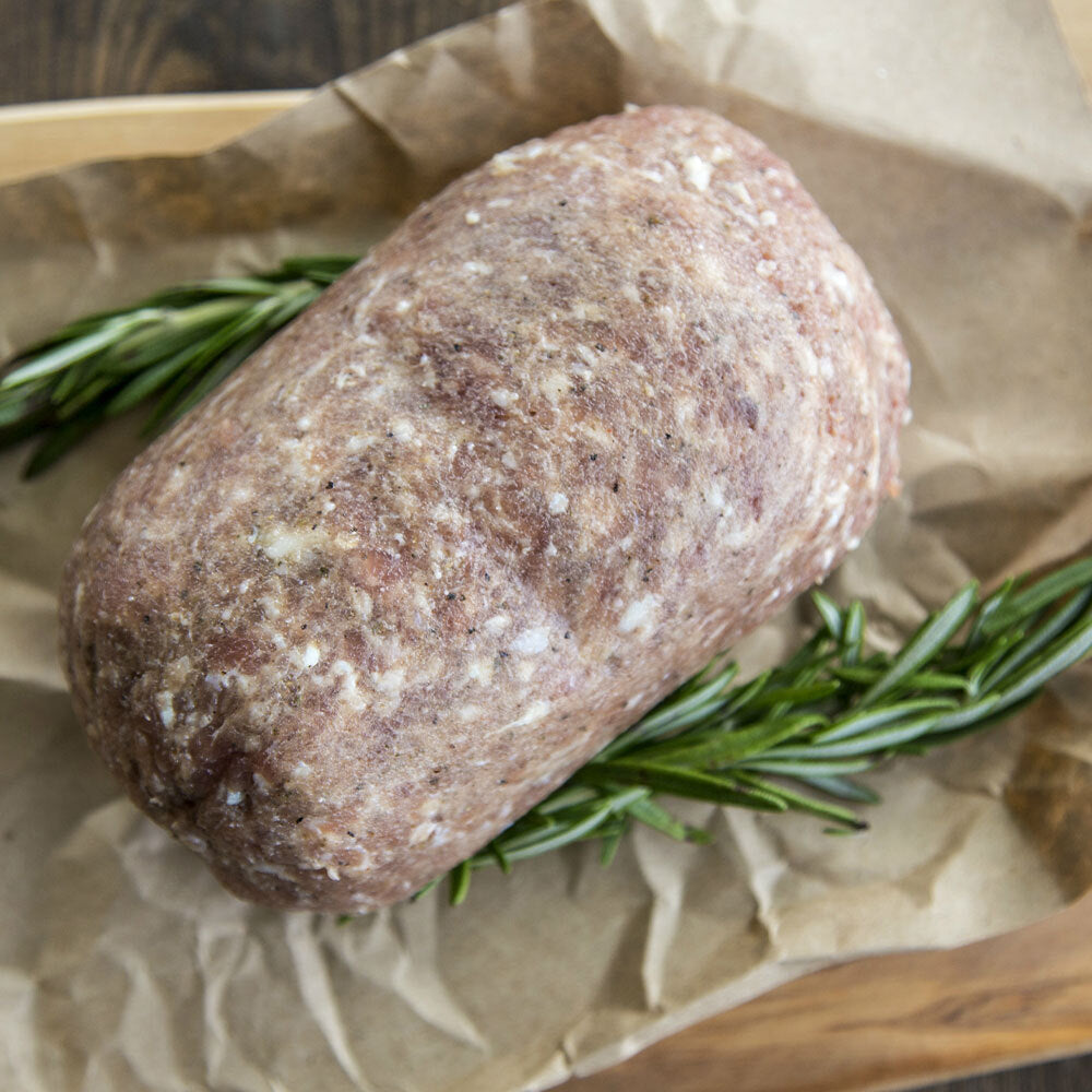 Raw salt and pepper sausage on butcher paper, bulk-style ground pork
