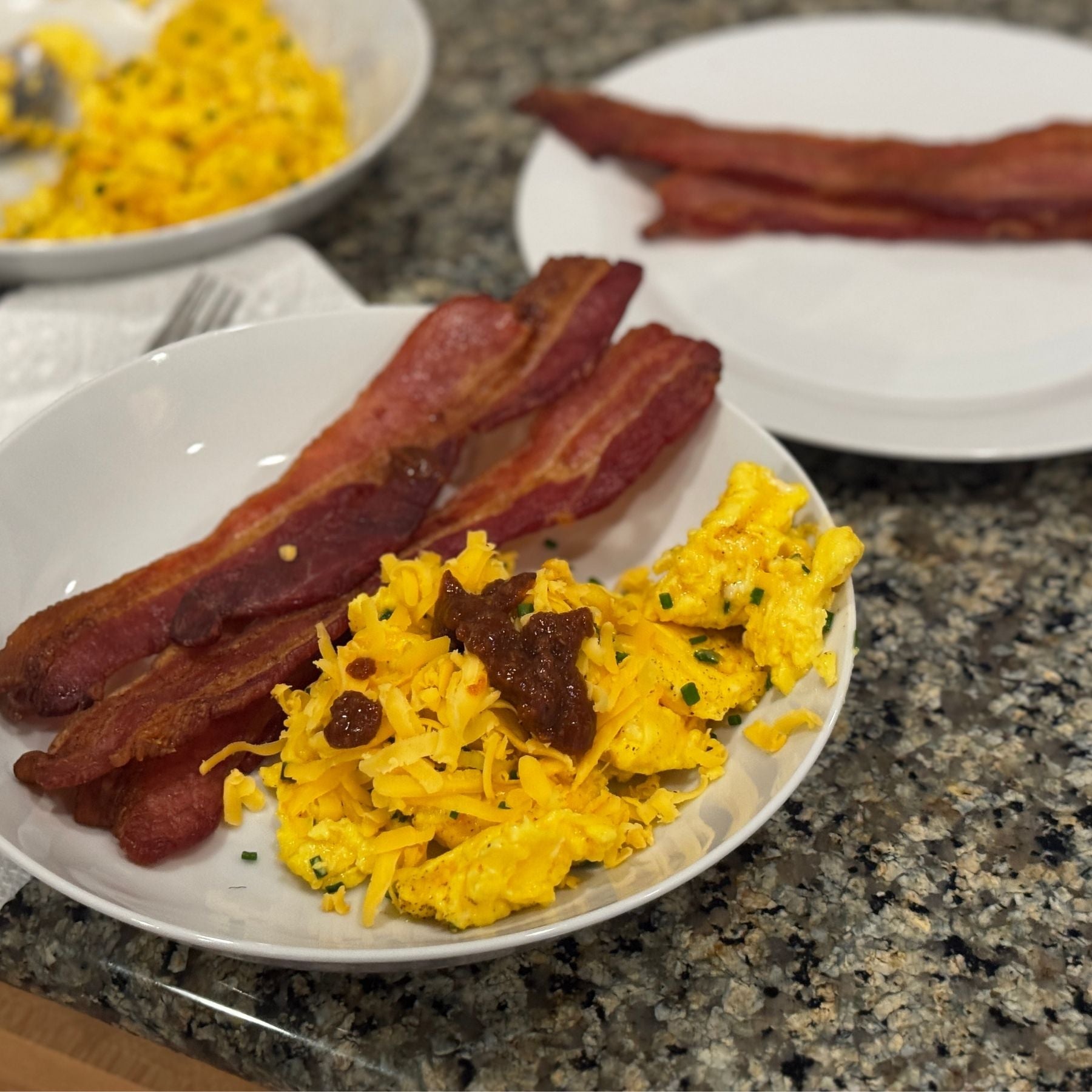 Smoking Goose Applewood Smoked Bacon with scrambled eggs, available through Tyner Pond Farm