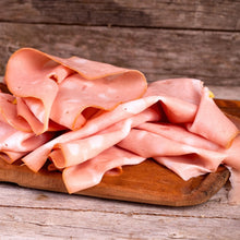Mortadella slices served on a wood board as a serving suggestion for Smoking Goose Mortadella