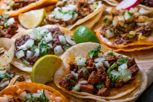 Grassfed top round steak sliced in tacos with onion and cilantro