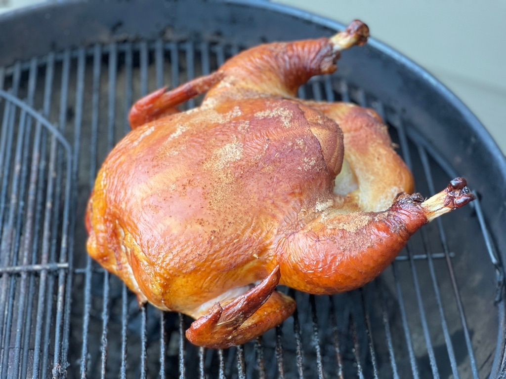 Top-down view of whole roast chicken with browned skin, pasture-raised