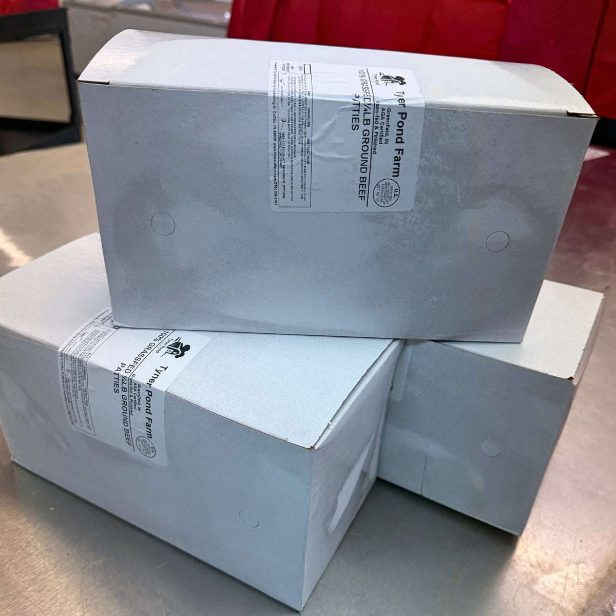 Tyner Pond Farm 100% grass-fed ground beef packed in labeled boxes for customer orders and delivery.