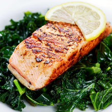 Cooked wild Alaska sockeye salmon served over local kale with lemon